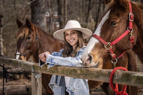 Lovely Brunette Cowgirl Enjoying A Day With Her Horse On Her Farm Stock