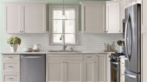 I'm finally sharing the crown molding my husband and i. Kitchen with antique white shaker style cabinets, crown ...