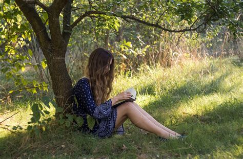 Girl Reading A Book Under A Tree Stock Photo Containing 20 29 And Girl