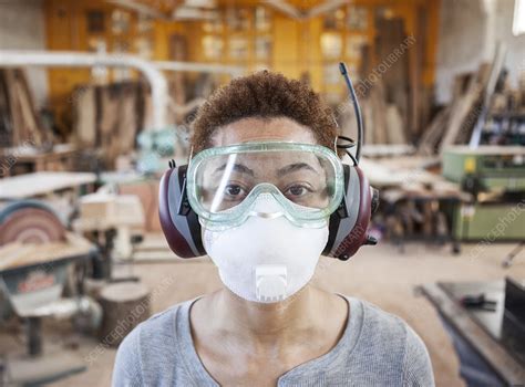 Worker Wearing Safety Glasses And Mask In A Factory Stock Image