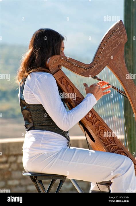 Closeup Of A Young Woman Playing The Harp On A Small Bandstand In Ronda