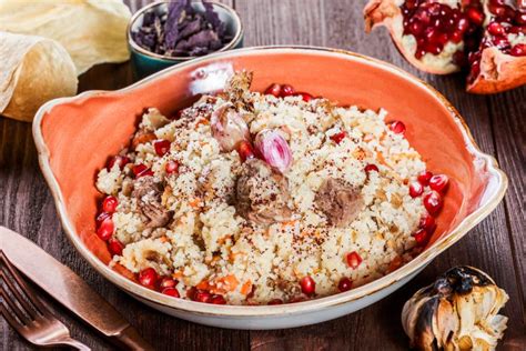 Pilaf With Lamb Meat Carrots Onions Garlic Pomegranate On Plate On