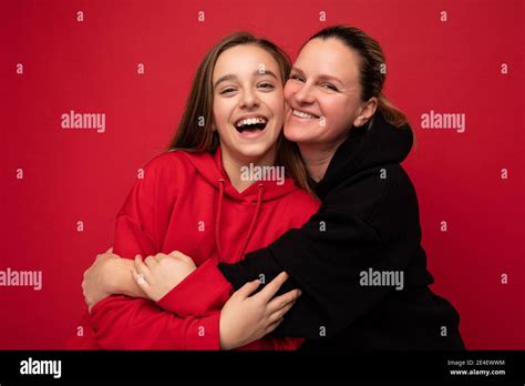 Cute Photo Shot Of Beautiful Happy Smiling Brunette Daughter Wearing Stylish Red Hoodie And
