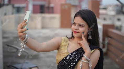 Premium Photo Beautiful Indian Girl Taking Selfie On Her Mobile Phone Outdoor Cheerful Asian