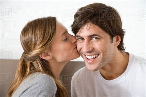 Woman Kissing Man On The Cheek Stock Photo Dissolve