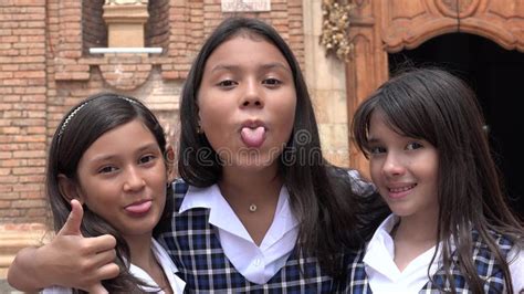 Young Colombian Female Students Making Funny Faces Wearing School
