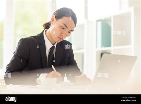 Handsome Businessman At Workplace Stock Photo Alamy