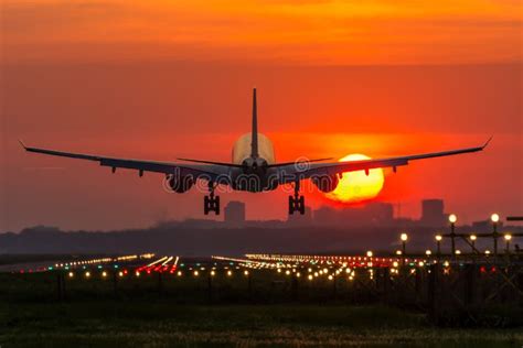 Airplane Is Landing During Sunrise Stock Image Image Of Plane