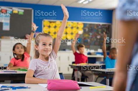 Children Raising Hands In Classroom Stock Photo Download Image Now