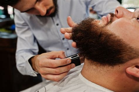 premium photo handsome bearded man at the barbershop barber at work