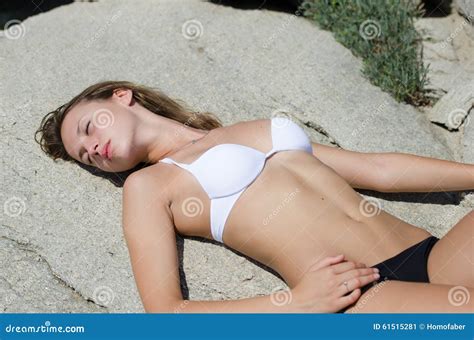 Woman Is Lying Down And Sunbathing On Solid Rocks Stock Image Image Of Fashion Rock