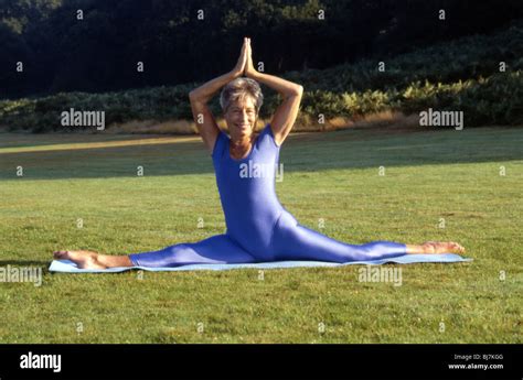 Mature Female Practising Yoga Outdoors Yoga Posture Landscape Image Of Older Woman In Yoga