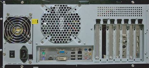 Back panel that contains holes to expose external ports. Behind a computer