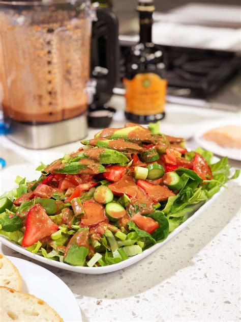 Strawberries on a bed of red leaf lettuce, garnished with red onions for a stunning color combination. How to Make a Vinaigrette - cooking with chef bryan