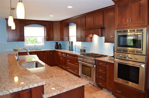 A light cherry color makes the white of the granite countertops really pop. Large island with granite, cherry cabinets. Stainless appliances. | Cherry cabinets, Kitchen ...