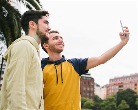 Free Photo Delighted Gay Couple Shooting Selfie On Street