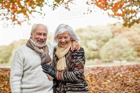 Older Couple Walking In Park Stock Photo Dissolve