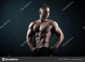 Young Handsome Strong Male Fitness Model Bodybuilder Poses On