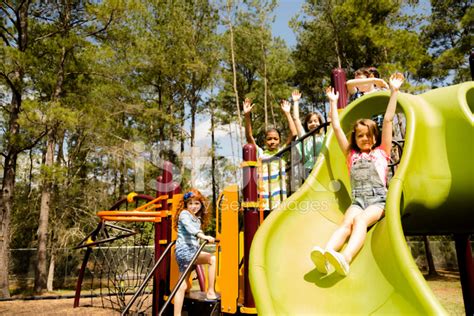 Elementary Children Play At School Recess Or Park On Playground Stock