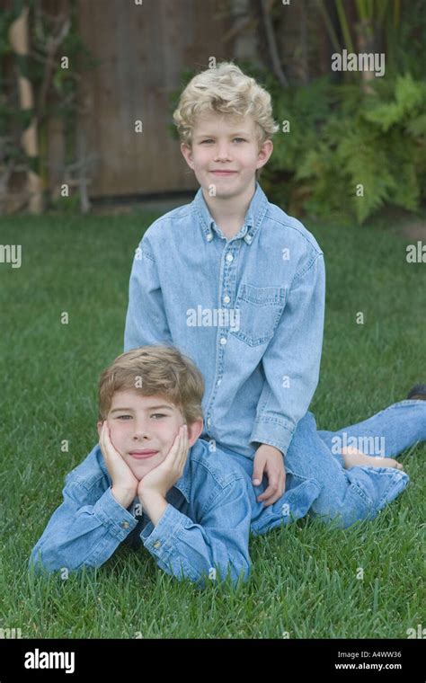 Younger Brother Sitting On Top Of Older Brother Stock Photo Alamy