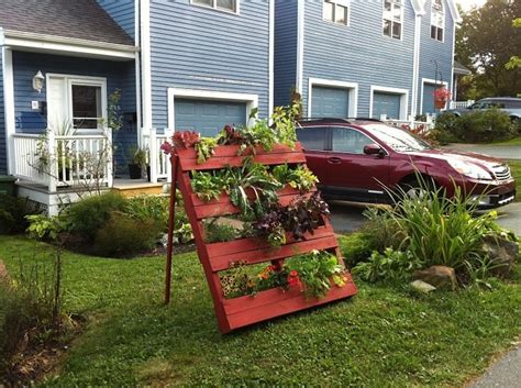 Creating a vertical garden with a wood pallet. 25 Ways Of How To Use Pallets In Your Garden