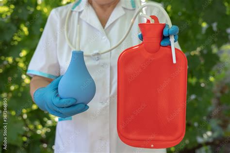 nurse hold blue enema and red enema bag medical gastrointestinal colon background concept