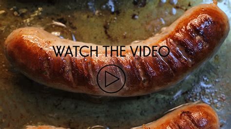 Two Sausages Sitting On Top Of A Pan With The Words Watch The Video Below