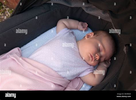 Little Baby Girl Asleep In Her Pram Outside Stock Photo Alamy