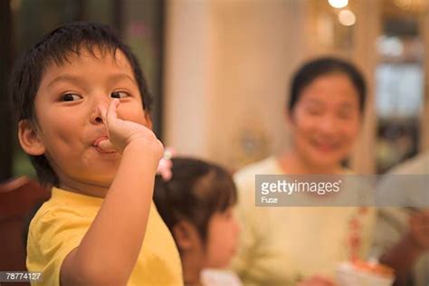 Asian Woman Licking Finger Photos Et Images De Collection Getty Images