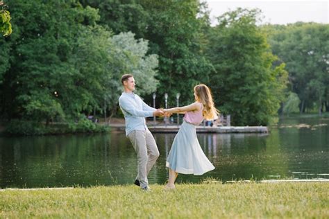 Premium Photo A Romantic Couple In Love Holding Hands And Spinning On