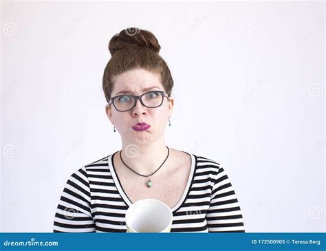 Pouty Faced Woman Is Out Of Coffee And Shows Empty Cup On A White