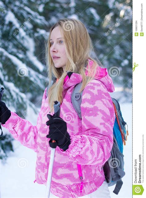 Attractive Caucasian Woman Hiking In Winter Snowy Forest Stock Photo