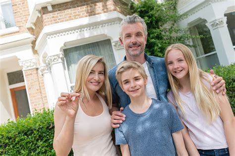 Maybe you would like to learn more about one of these? Family Holding Keys To Their New House Stock Photo ...