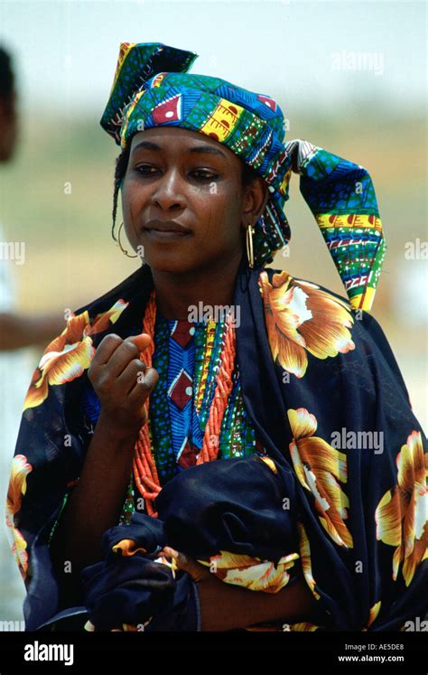 Nigerian Woman In Brightly Coloured Clothes And With The Traditional