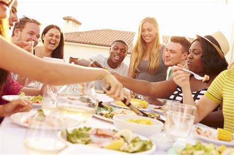 Group Of Young People Enjoying Outdoor Summer Meal Calorie Control