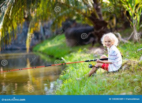 Boy Fishing Child With Rod Catching Fish In River Stock Image Image