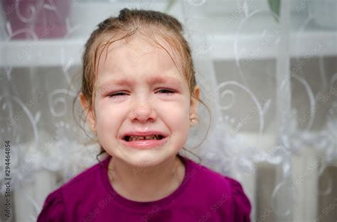 Little Girl Sitting On The Floor She Is Upset And Crying The Child Is