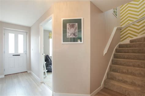 Neutral tones with a dramatic wallpaper - the perfect entrance to your