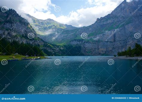 Scenic View Of Oeschinen Lake Among The Mountains In Kandersteg