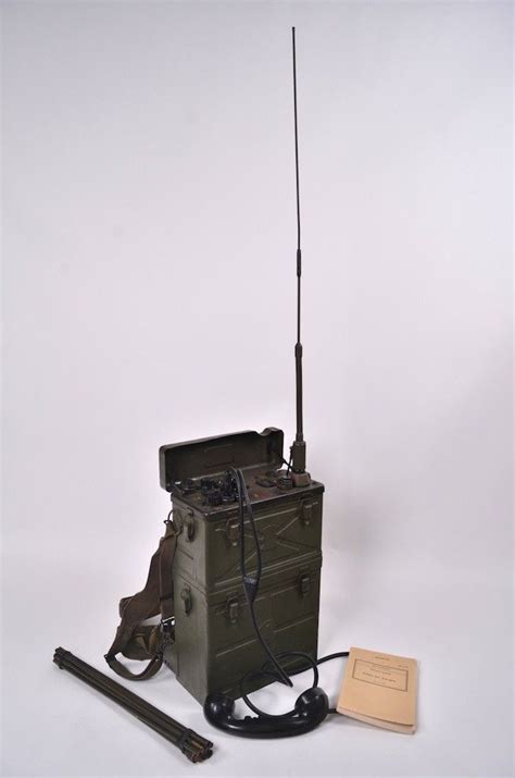 An Old Army Radio Sitting On Top Of A Box Next To A Pair Of Scissors