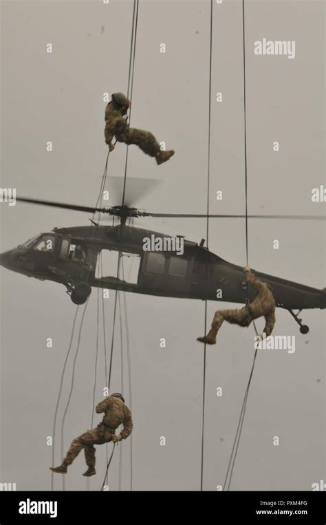A Soldier Rappels Out Of A Uh 60 Black Hawk Helicopter During The Air