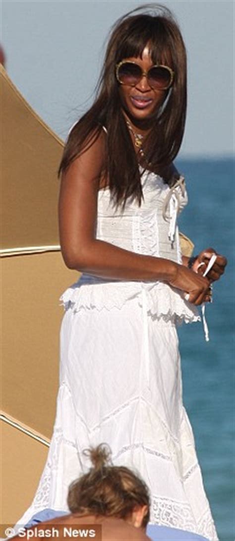 naomi campbell shows off her supermodel figure and her underwear on the beach daily mail online