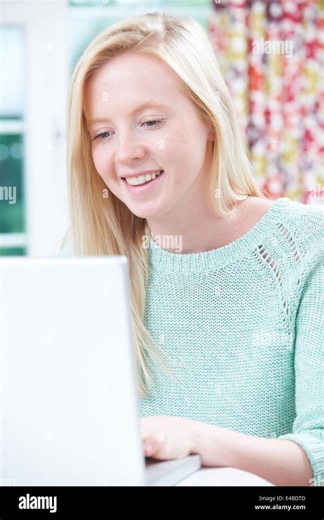 Happy Teenage Girl Using Laptop At Home Stock Photo Alamy