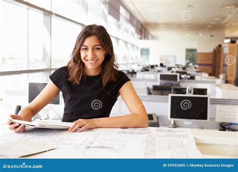 Young Female Architect Working With Computer And Blueprints Stock Image