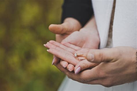 Premium Photo Wedding Rings In The Hands Of The Newlyweds