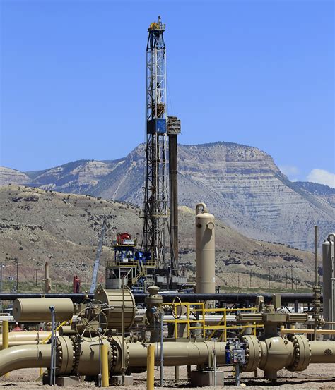 A Natural Gas Drilling Rig Operates As Natural Gas Piping Rises From