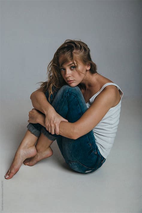 Girl Sitting On The Floor Hugging Her Legs By Danil Nevsky