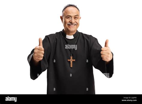 Happy Priest Gesturing With Both Thumbs Up And Smiling At Camera