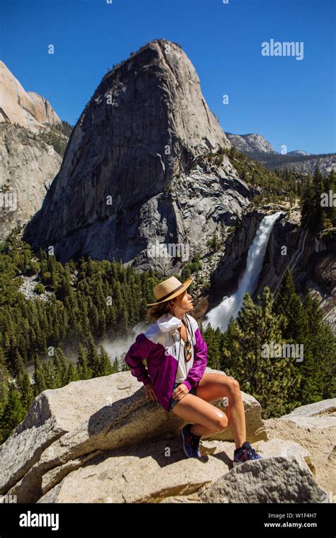 Tourist Woman Sitting On Rock In John Muir Trail With Nevada Fall And