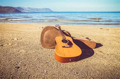 Acoustic Guitar On A Beach Picture Id545285720 511×339 Photo